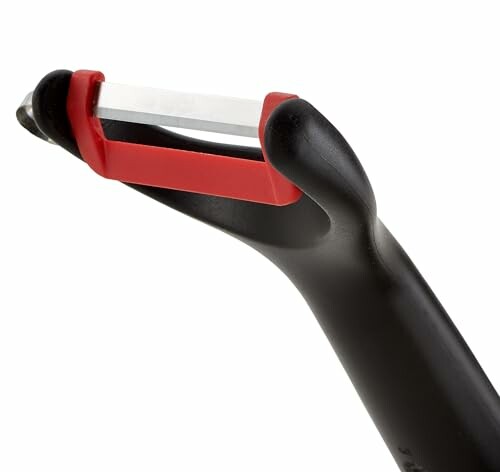 Éplucheur de légumes en céramique avec manche noir et rouge.